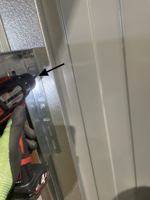 <p>Using a 5mm drill, drill a hole in the top small hole.</p>