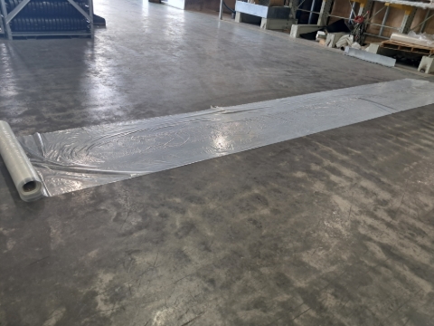 <p>Get the protective plastic and line the trolley with it. The plastic will need to be 1-3 metres longer then your product depending on the amount so it can wrap around the ends. Make sure the plastic is equal at both ends.</p>