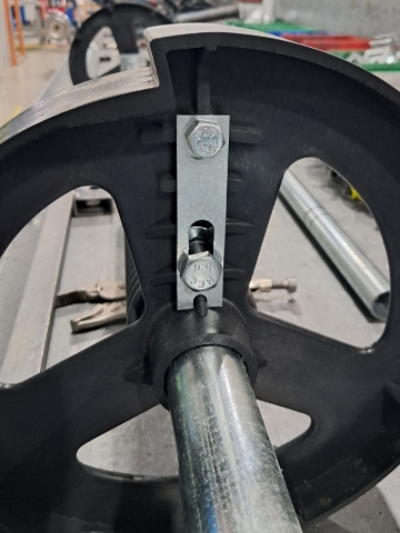 <p>With 4 sheet roller doors, you'll need to add a bracket and an additional bolt and nut, to the top hole of the wheel. No washers needed for the outside.</p>