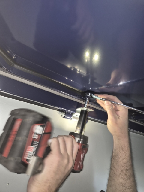 <p>Using the rattle gun and spanner, tighten the bolts that attach the walls to the roof.</p><p>Repeat for every wall.</p>