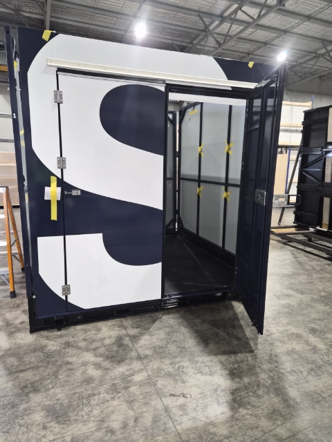 <p>Lifting the front wall will be a two-person lift.</p><p>Each person holds open a door and lifts the wall at the same time and together.</p>