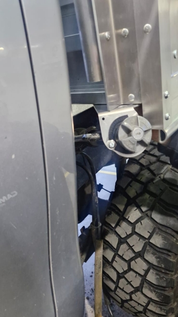 <p>Install the bracket to hold the fuel filler to the flat deck, and fit the filler to the bracket and tighten it to spec.</p>