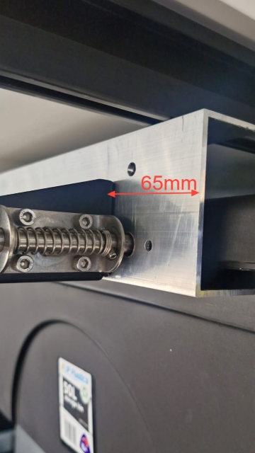 <p>65mm from the latch bracket and end of the rail.</p>