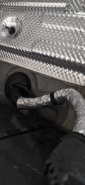 <p>Route the loom along the top of the chassis and locate this grommet under the driver's seat. Punch a hole through and put the loom through.</p>