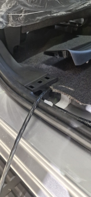 <p>Pull the loom up through the passenger side in the rear of the cab.</p>