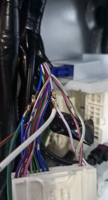 <p>Find the light purple wire and connect the white wire from the in-cab wiring to it. Ensure to solder and wrap with electrical tape.</p>