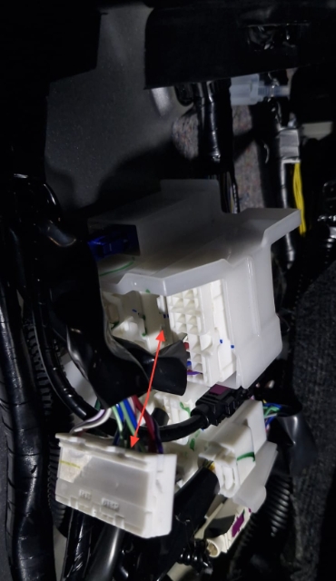 <p>After opening up the trim, locate this junction of wiring and unclip the plug shown.</p>