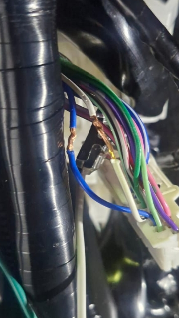 <p>Using a pair of wire strippers, strip back approximately 10mm of insulation from both the Blue wire and the White/Black (White with Black stripe) wire.</p>