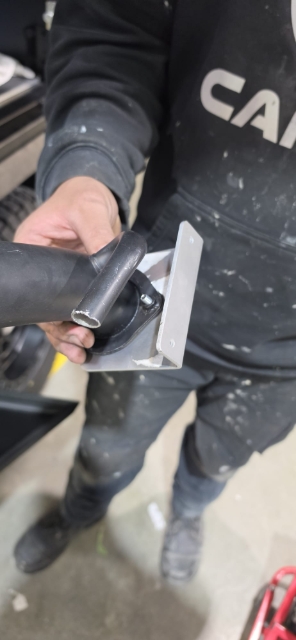 <p>Fit the fuel fille to the mounting bracket.</p>