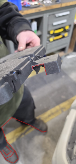 <p>Cut the areas shown so the wire can fit out for the battery-to-fuse box connection.</p>