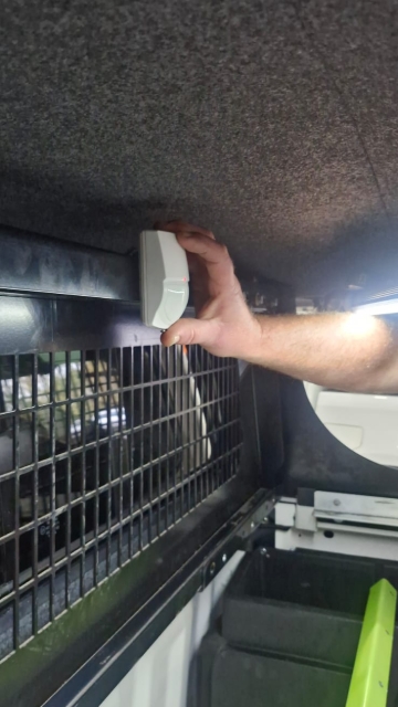 <p>Attach the sensor to the middle of the cargo barrier using double-sided tape.</p>