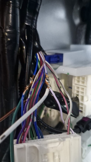 <p>Find the light purple wire and connect the white wire from the in-cab wiring to it. Ensure to solder and wrap with electrical tape.</p>
