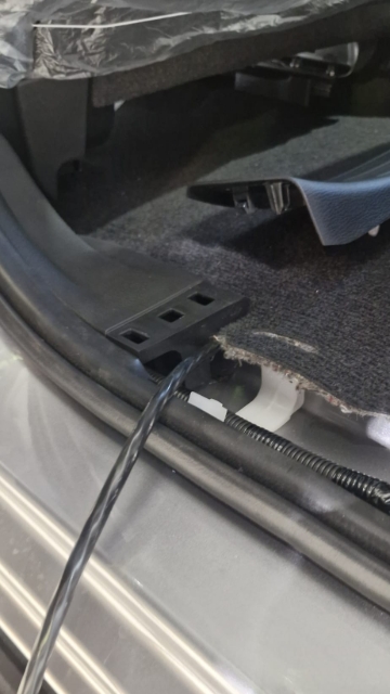<p>Pull the loom up through the passenger side in the rear of the cab.</p>