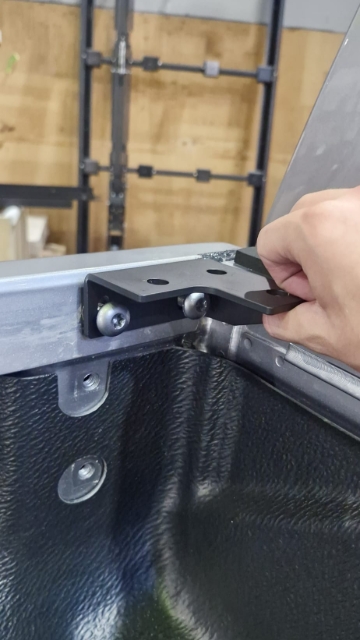 <p>Position the brackets at the cab-end corners and secure them using the original factory screws removed from the wellside.</p>