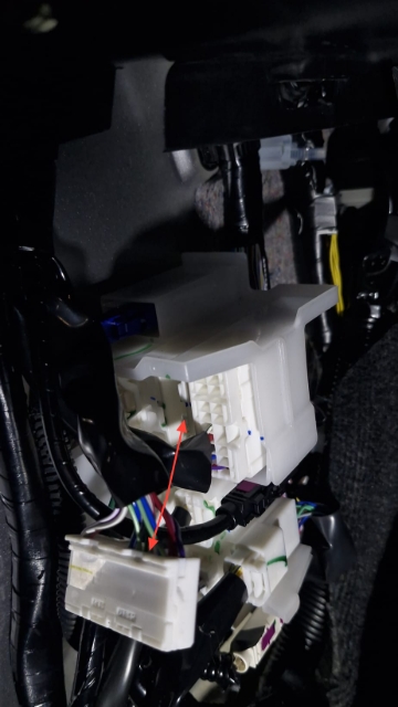 <p>After opening up the trim, locate this junction of wiring and unclip the plug shown.</p>