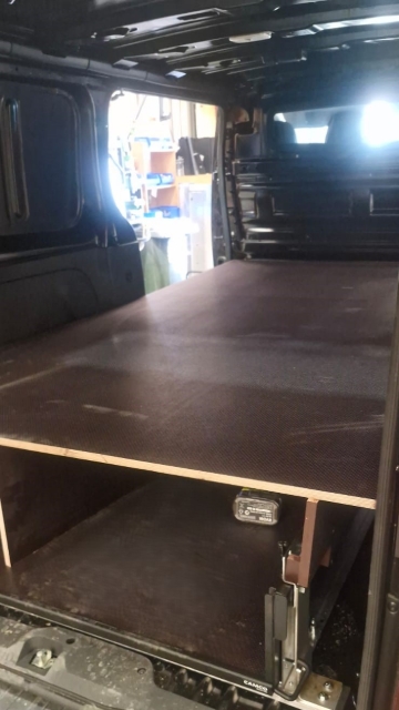 <p>Lift the false floor into the rear of the van.</p>
