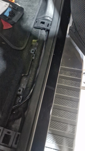 <p>Pull up the trim at the rear of the cab to route the wire underneath.</p>