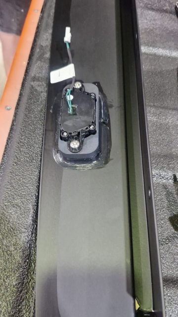<p>Fit the switch to the tailgate rail and urethane around the edges to prevent leaking.</p>