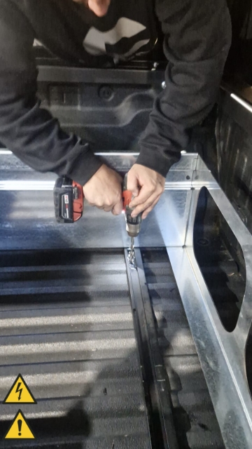 <p>Before drilling through the rear, check underneath for wiring or any critical areas.</p><p></p><p>Drill through the low-profile bar each side as shown.</p>