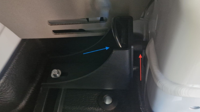 <p>Mount the rear brackets to the van’s tie-down points. Position the spacer behind the bracket (Red Arrow) and secure the tie-down point to the front of the bracket (Blue Arrow) using the factory hardware</p>