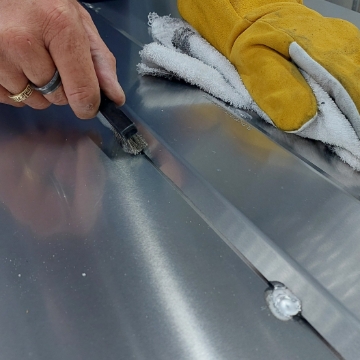 <p>Clean welds with rag and wire brush.</p>