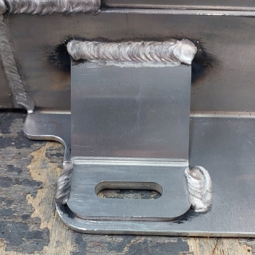 <p>MIG weld gussets as shown.</p><p>Clean welds with rag and wire brush.</p>