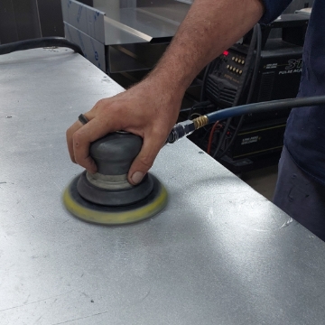 <p>Clean work bench with Orbital Sander and rag.</p>