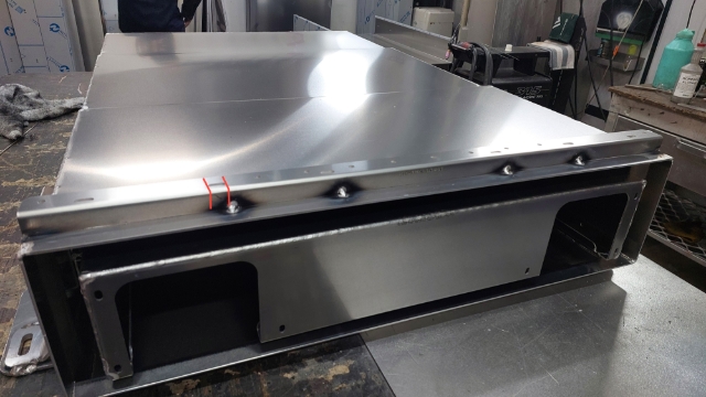 <p>Prep camera bracket for welding. </p><p>Locate camera mount 26mm back from front edge of drawer. </p><p>Tack weld each end of bracket and use slots in bracket as weld indicators for centre weld tacks.</p>