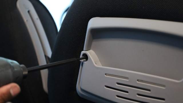 <p>Next remove the cover on the back of the seat.</p>