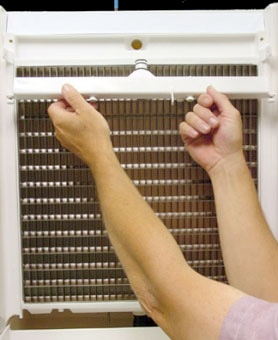 <p>Remove the water distribution tube. Loosen the two outer screws (do not remove them completely — they are retained to prevent loss). Pull forward on the distribution tube to release it from the slip joint and remove it. Disassemble the tube by loosening the two middle thumbscrews and dividing it into two pieces.

48" models have two water distribution tubes — remove both.</p>