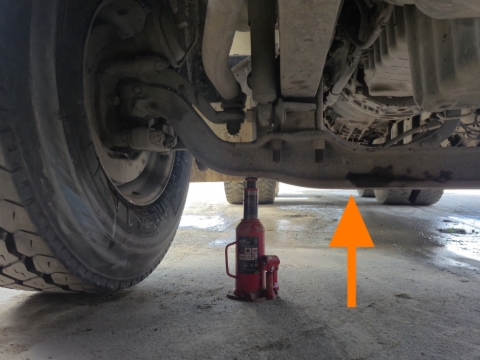 <p><strong>Front Axle Beam</strong></p><p>The axle beam is a good place to jack under if you need to jack the front wheels. </p><p>It is always accessible and provides a flat solid surface. </p><blockquote><p>You are also able to jack further under the truck where the axle beam is a bit lower (orange arrow) as that outer piece can sometimes be too high.</p></blockquote><p></p>