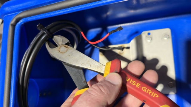 <p>Free the pump power wires by snipping the cable ties.</p>