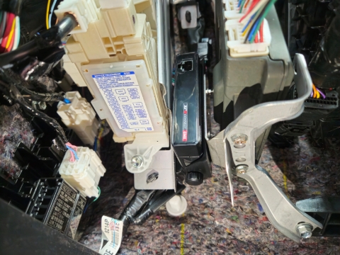 <p><strong>Step 4:</strong> Slide the bracket into position as pictured, and tighten bolts from step 2.</p><p>Replace glovebox after wiring is complete.</p>