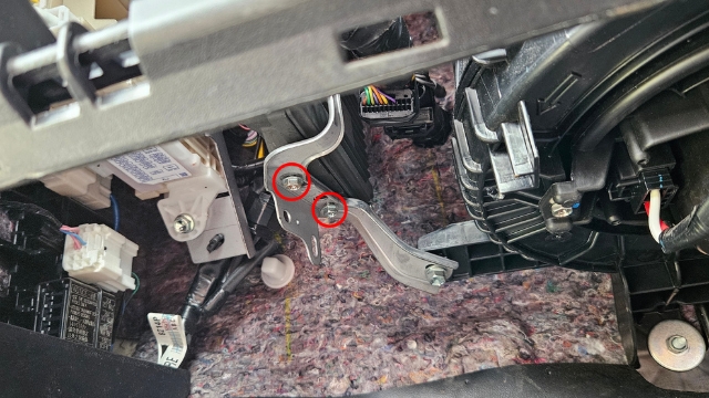 <p><strong>Step 2</strong>: Partially loosen the two bolts indicated</p>
