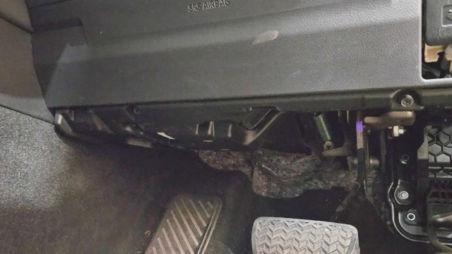 <p>9.</p><p>Repeat Steps 4 and 5 on drivers side.</p><p>Remove the two screws circled and pull
down to detach panel.</p>