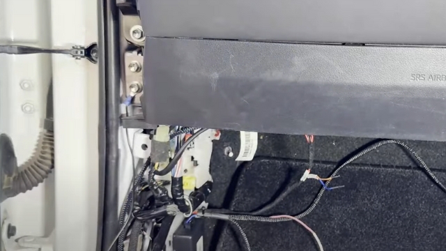 <p>5.</p><p>Remove the side access panel and attach the earth cable.</p><p>Remove larger connector circled (located near firewall grommet)</p>