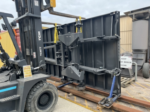 <p>Drag the trailer out of the container.</p><p>To move it around, find the balance point so it lifts level and lift it from the upper main deck rail using a basket sling fed through behind the combing rail.</p>