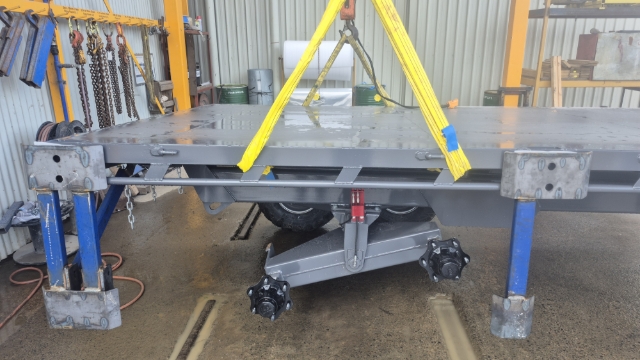 <p>If the wheel assemblies have been removed, bolt them back on the unit.</p><p>the middle stand will need to be removed for this.</p>