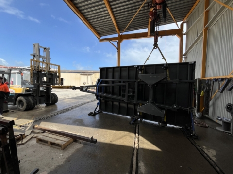 <p>Attach each sling set to a separate gantry hook or sling from a forklift.</p><p></p><p>In this scenario we are lifting with two Gantries and are off center. In this situation, we are using a forklift with a tow hitch connected to the towing eye to balance the off centered weight.</p>