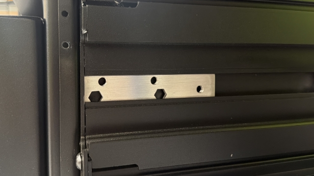 <p>Slide 1 bearing thread plate down the centre extrusion from the front of the service body.</p><blockquote><p><strong>CQC: </strong>Ensure the 2 hexagon cut-outs are positioned at the bottom rear.</p></blockquote><p></p>