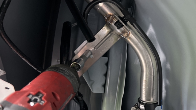 <p>Using an 8mm socket, remove the fuel filler mounting bolt.</p>
