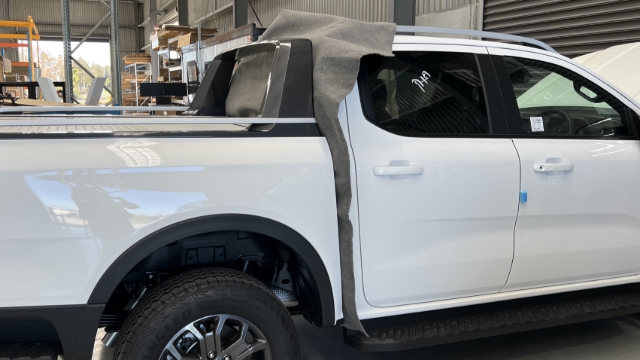 <p>Put the protective liner between the tub and cab.</p>