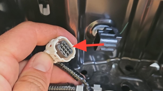 <p>Remove reverse sensor connectors </p><blockquote><p><strong>CQC:</strong> Use extreme caution with removal</p></blockquote><p><em>Use pry tool or flat screw driver to help depress connector </em></p>