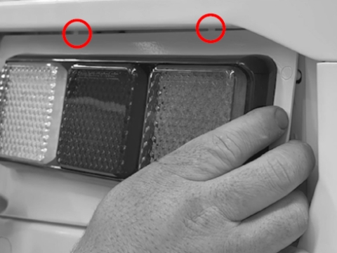 <p>Remove the light plate from the bumper and by sliding this out of the bumper and locator grooves on the top.</p>