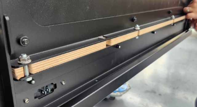 <p>Undo the 4 bolts clamping the drawer to the ply.</p><p>You can now remove the drawer backing plate and access the drawer.</p><p>This will allow you to remove the false floor (if needed) and access the front of the latch assembly for further troubleshooting.</p>
