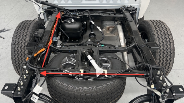 <p>Route the wiring harness as shown towards the engine bay.</p>