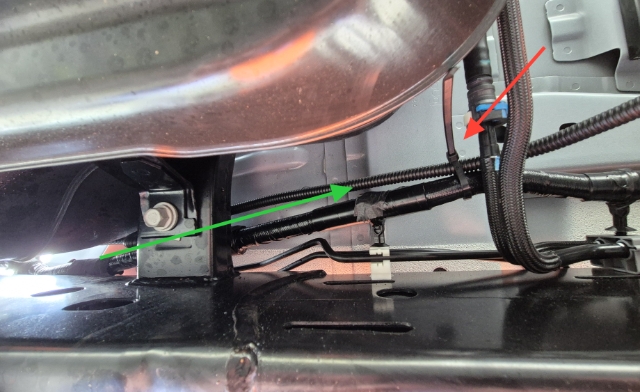 <p>Follow over a support beam along the factory wiring harness towards the engine bay on the inside of the chassis rail ensuring no contact with vehicle brake or fuel lines.</p>