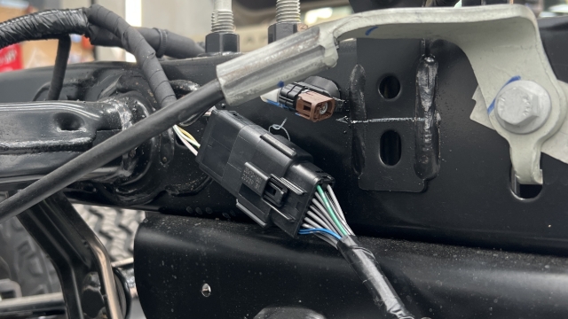 <p>Plug the wiring harness in at the rear drivers side of the chassis.</p>