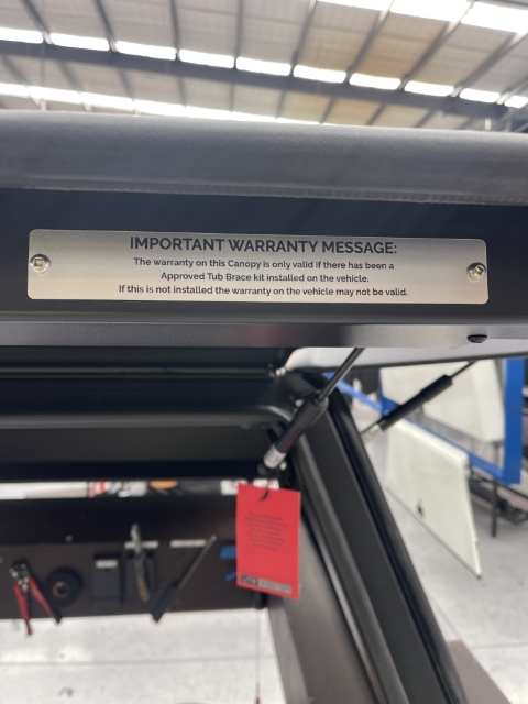 Warranty plate mounted to rear door