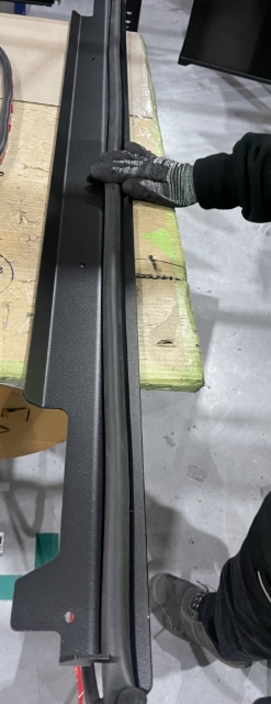 Rear water seal bulb seal applied to tailgate bracket and packaged